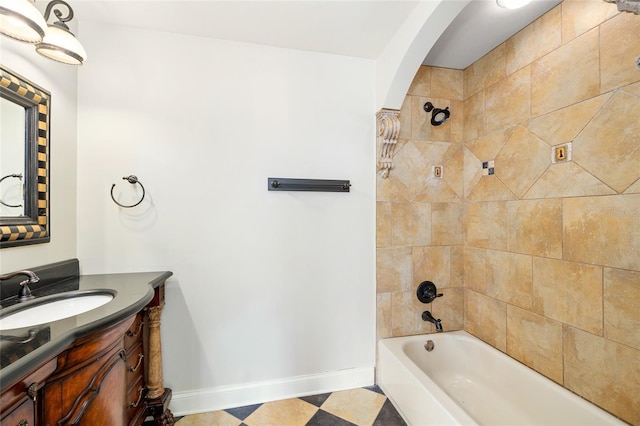 full bath with tile patterned floors, vanity, washtub / shower combination, and baseboards