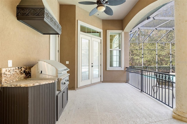 sunroom / solarium featuring french doors and ceiling fan