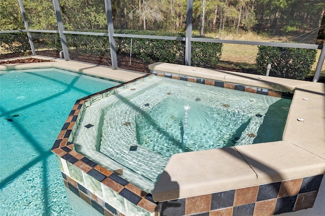 outdoor pool with glass enclosure and an outdoor hot tub