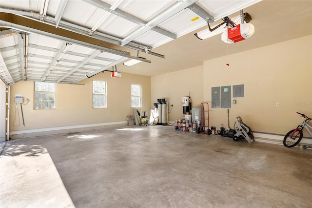 garage featuring a garage door opener, electric panel, and baseboards