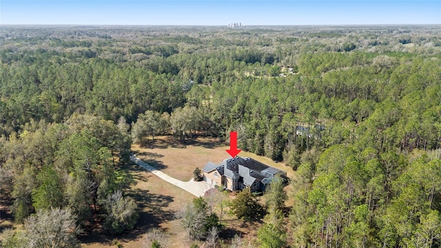 birds eye view of property with a view of trees