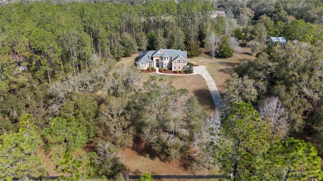 birds eye view of property with a view of trees