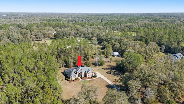 birds eye view of property with a wooded view