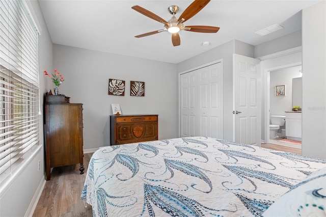 bedroom with a closet, visible vents, a ceiling fan, light wood-type flooring, and baseboards