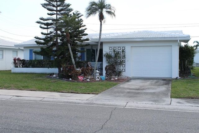 ranch-style home featuring a tiled roof, an attached garage, driveway, and stucco siding