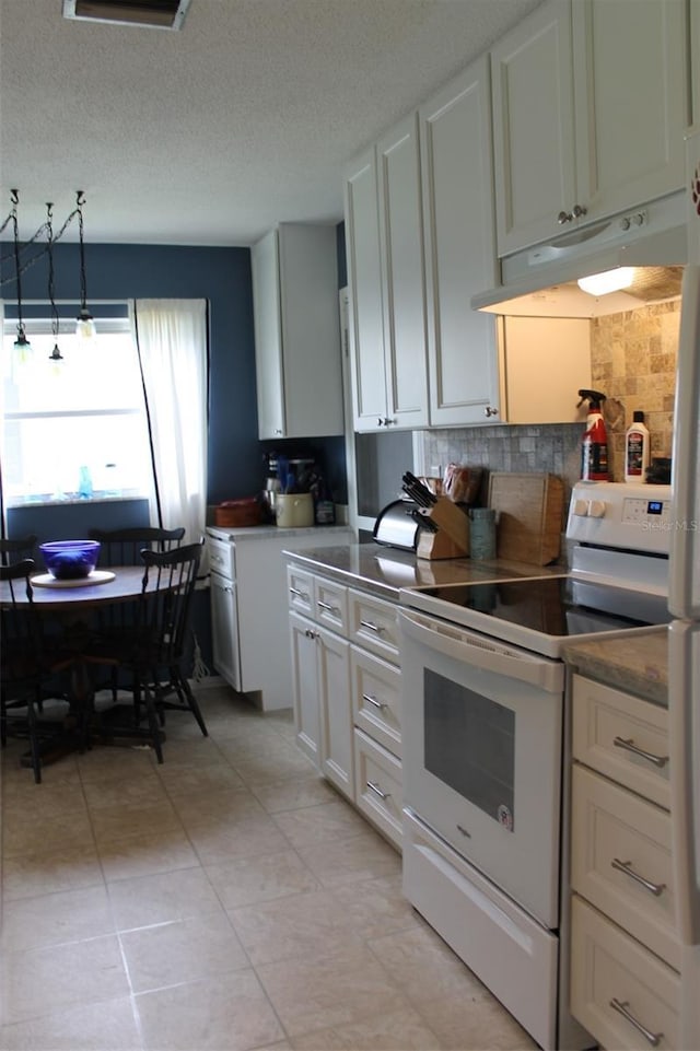 kitchen featuring pendant lighting, white range with electric cooktop, tasteful backsplash, white cabinetry, and under cabinet range hood