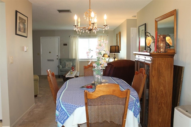 dining space with light carpet, baseboards, visible vents, and a chandelier