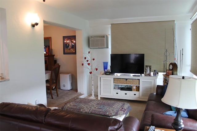 living room with a wall unit AC and light tile patterned floors