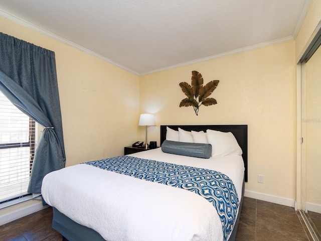 bedroom featuring baseboards, tile patterned floors, and crown molding