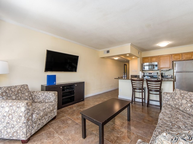 living area with baseboards, visible vents, and crown molding