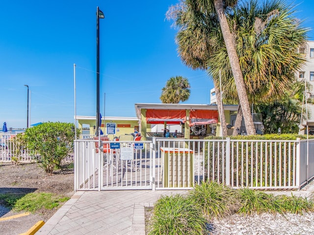 view of home's community featuring fence