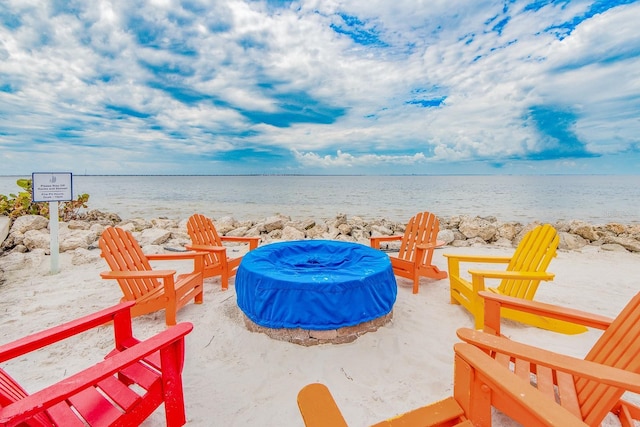 view of patio / terrace with a water view and a view of the beach