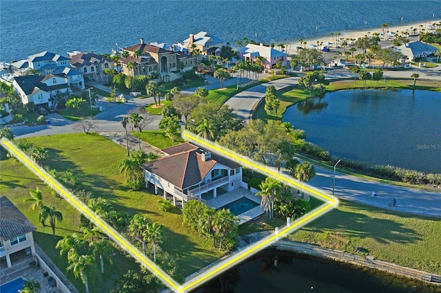 bird's eye view featuring a water view and a residential view