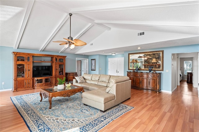 living area with light wood finished floors, visible vents, and a ceiling fan