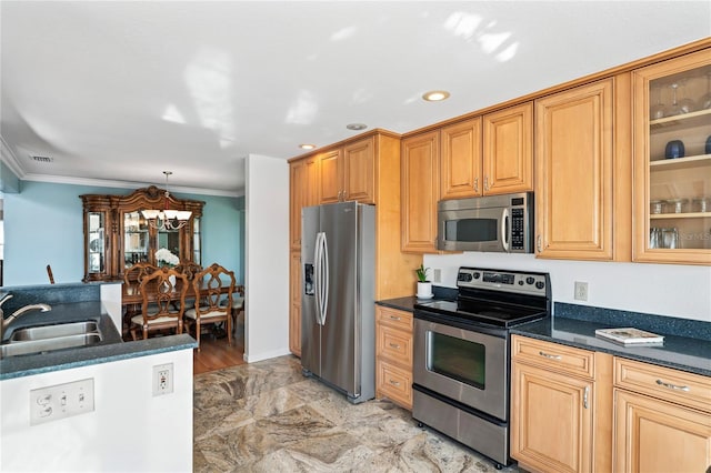 kitchen featuring dark countertops, visible vents, appliances with stainless steel finishes, ornamental molding, and a sink