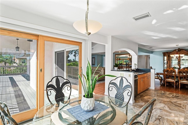 dining space with visible vents, arched walkways, and ornamental molding