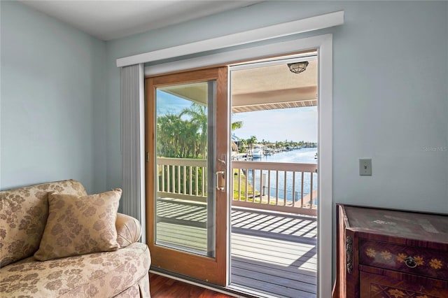 doorway featuring a water view and wood finished floors