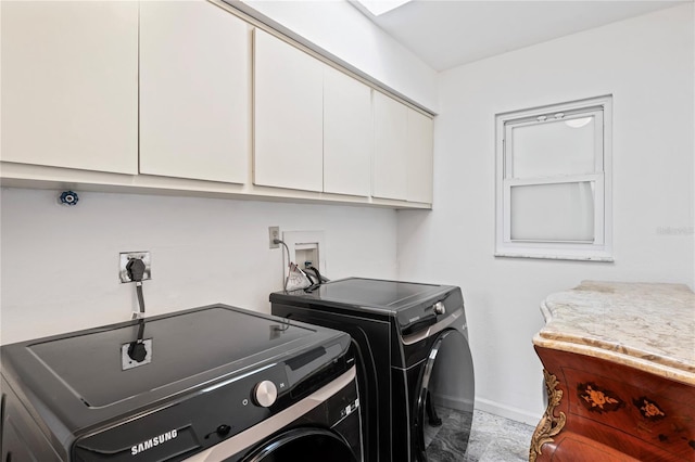 laundry room with cabinet space, baseboards, and washer and dryer