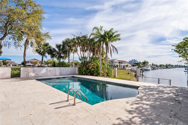 view of swimming pool with a fenced in pool, a water view, fence, and a patio