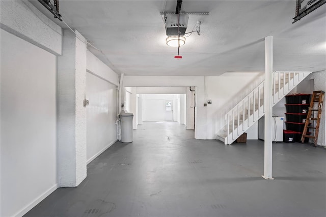 garage with baseboards and a garage door opener