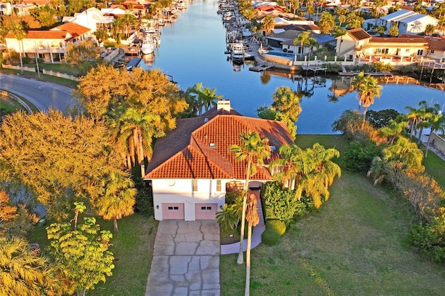 birds eye view of property with a residential view and a water view