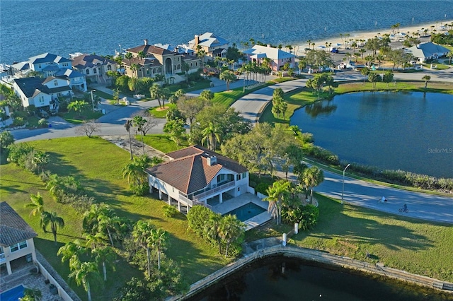 drone / aerial view with a water view and a residential view