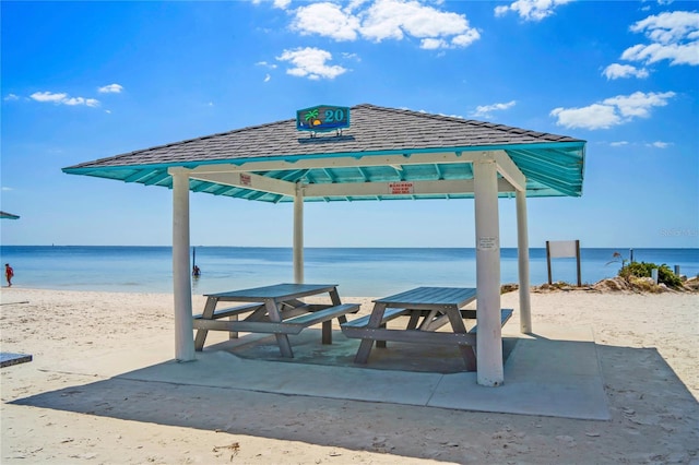 view of home's community with a water view, a beach view, and a gazebo