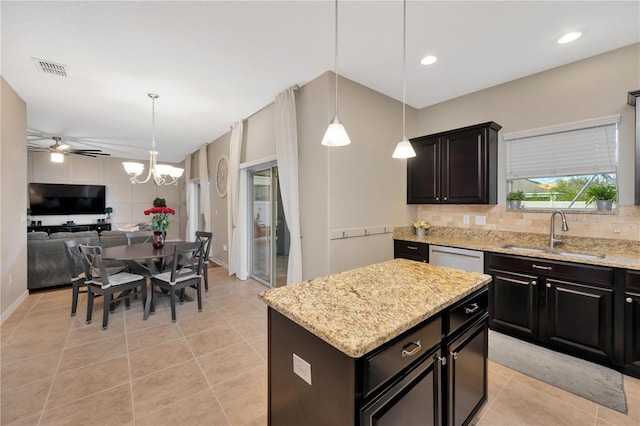 kitchen with open floor plan, a sink, decorative backsplash, and light tile patterned floors