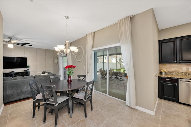 dining space featuring light tile patterned floors, baseboards, and ceiling fan with notable chandelier