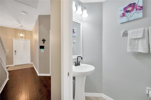 bathroom featuring hardwood / wood-style flooring and baseboards