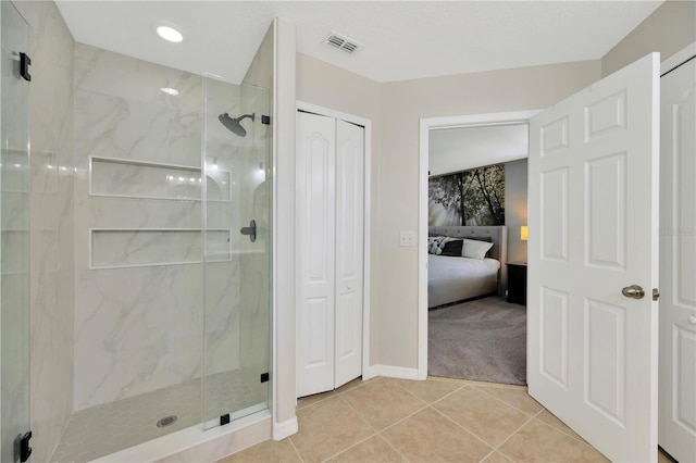 full bath with a marble finish shower, visible vents, ensuite bath, tile patterned flooring, and a closet