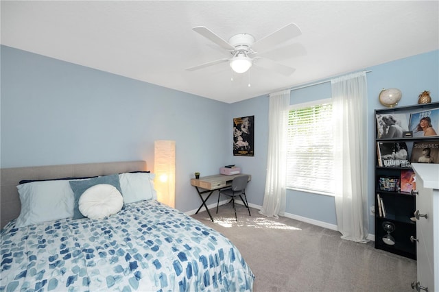 carpeted bedroom featuring baseboards and a ceiling fan