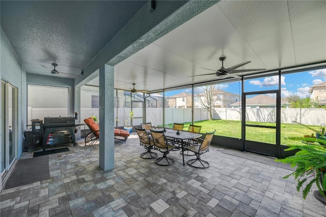 sunroom / solarium with a ceiling fan