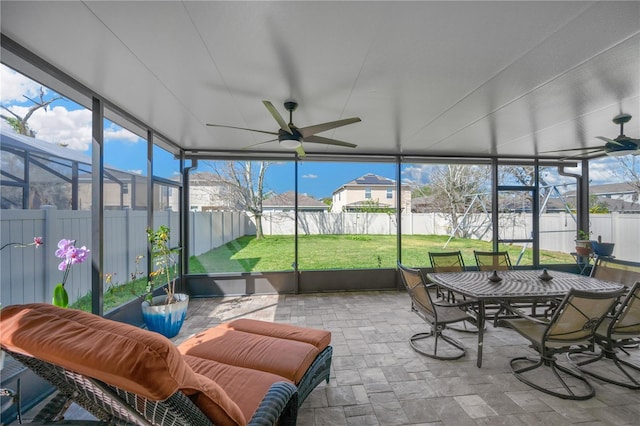 sunroom with a ceiling fan