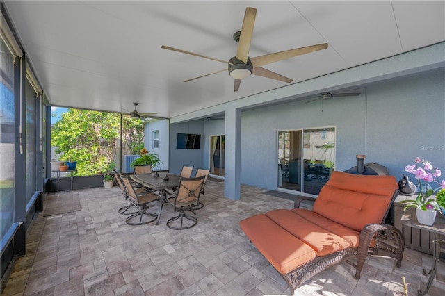 sunroom featuring ceiling fan