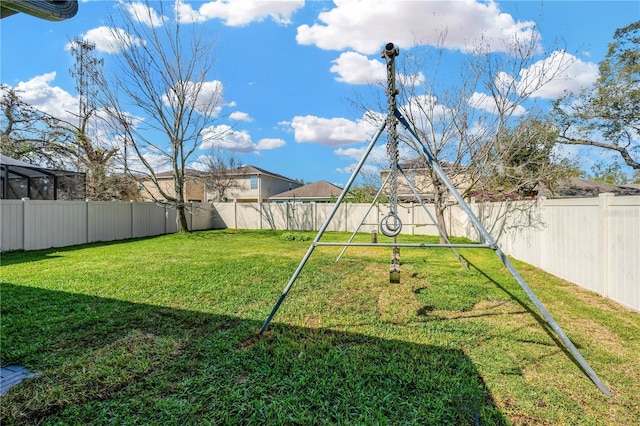 view of yard with a playground and a fenced backyard