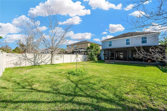 view of yard featuring a sunroom and a fenced backyard