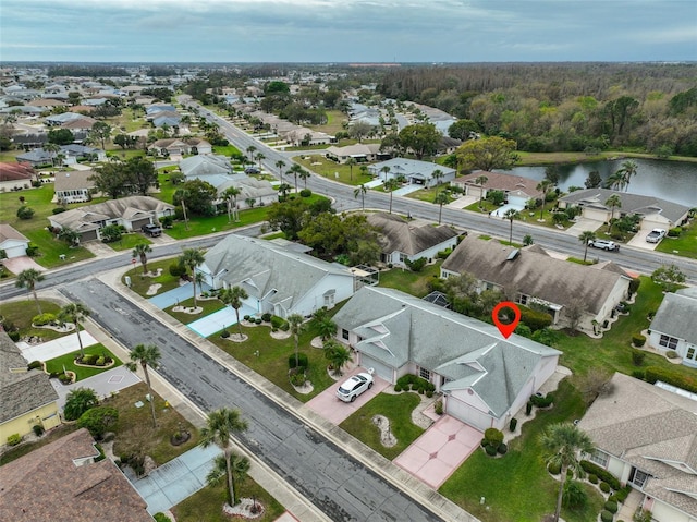 birds eye view of property with a water view and a residential view