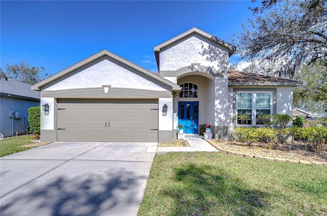 view of front facade featuring a garage, concrete driveway, a front yard, and stucco siding