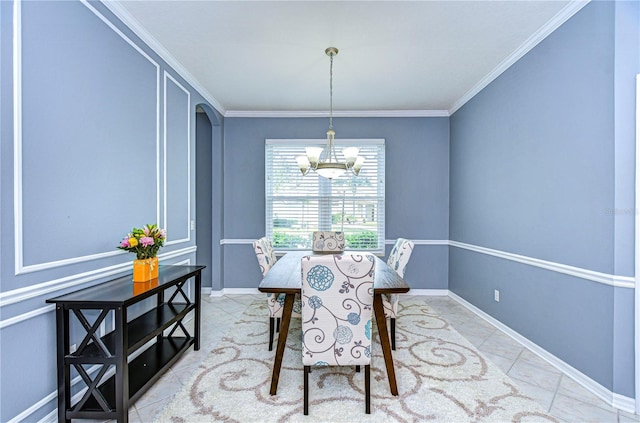 tiled dining area featuring baseboards, ornamental molding, arched walkways, and a notable chandelier