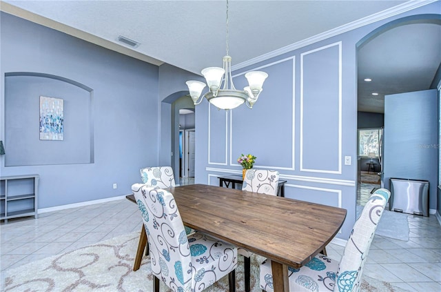 tiled dining room featuring arched walkways, visible vents, a decorative wall, a chandelier, and baseboards