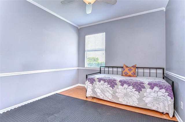 bedroom with a ceiling fan, baseboards, ornamental molding, and wood finished floors