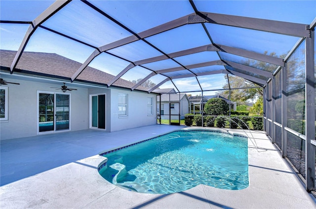 pool with a lanai, a patio area, and ceiling fan