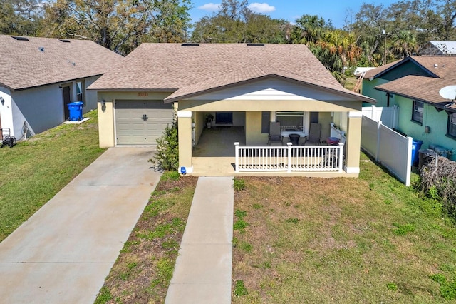 view of front of property with a porch, a front yard, roof with shingles, and fence