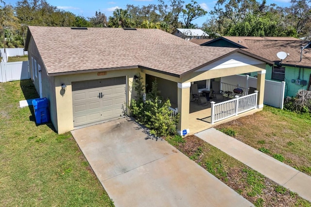 ranch-style house with a shingled roof, a front yard, and fence