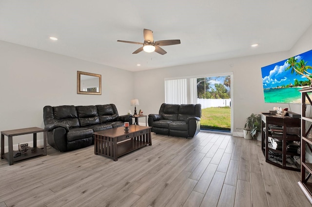 living room with light wood-style flooring, a ceiling fan, and recessed lighting