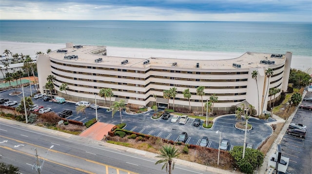 drone / aerial view featuring a beach view and a water view