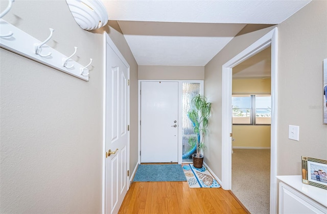 foyer entrance featuring light wood-type flooring and baseboards