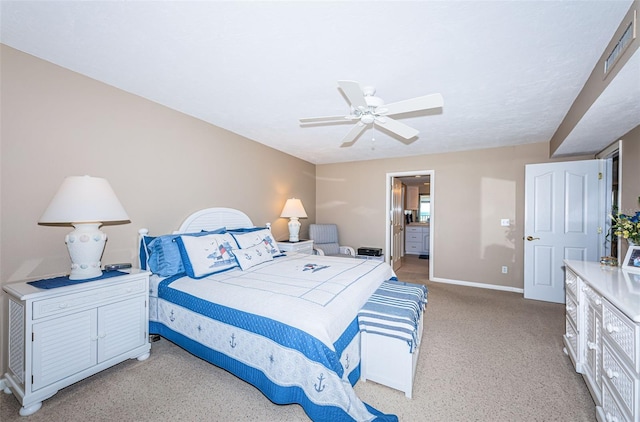 bedroom featuring ceiling fan, ensuite bathroom, and baseboards