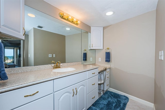 bathroom featuring vanity, recessed lighting, visible vents, and baseboards